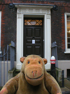 Mr Monkey looking at the front door of Dr Johnson's house