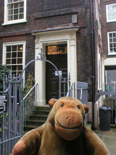 Mr Monkey looking at the side door of Dr Johnson's house