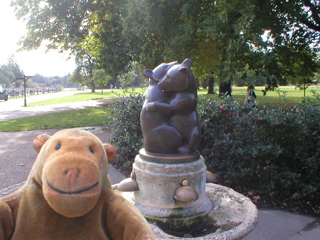 Mr Monkey looking at the fountain with the two hugging bears