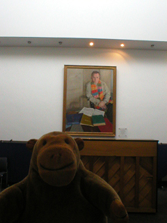 Mr Monkey looking at a portrait of Mark Elder