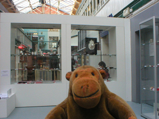 Mr Monkey looking at the Silver exhibition cases from a distance