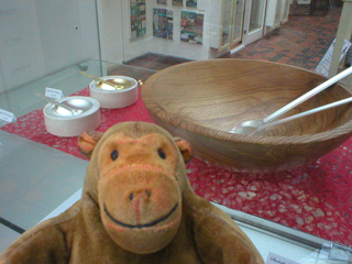 Mr Monkey looking at a salad bowl and salt and pepper dishes by Grant Braithwaite