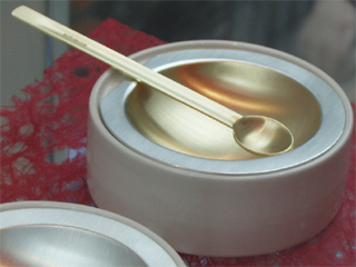 A lemon gilt salt dish and spoon by Grant Braithwaite