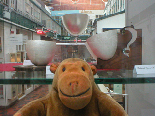 Mr Monkey looking at silver cups by Rajesh Gogna