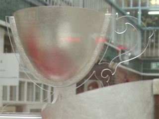 A silver cup with an acrylic handle