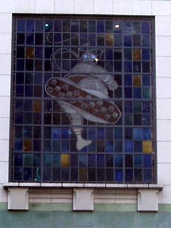 Stained glass showing the Michelin Man displaying the soles of his feet