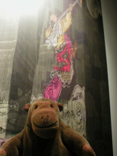 Mr Monkey looking at the Monkey King ascending a tower block