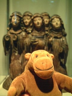 Mr Monkey in front of a row of carved nuns