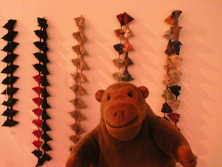 Mr Monkey looking at some suede chains by Carla Rosenfeld