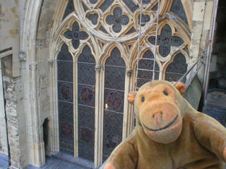 Mr Monkey looking at a stained glass window from the transept
