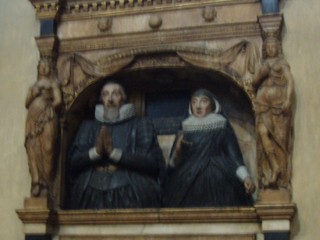 Statues of a husband and wife on a monument in the Quire