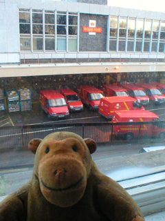 Mr Monkey watching the Royal Mail sorting office from his hotel window