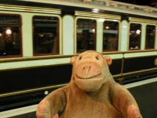 Mr Monkey looking at one of Edward VII's royal carriages