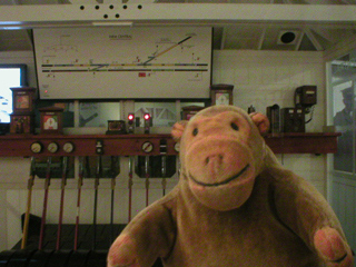 Mr Monkey looking at replica signalling equipment