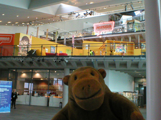 Mr Monkey looking up at the exhibition areas of Urbis