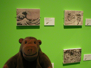 Mr Monkey looking at drawings by Hokusai