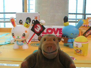 Mr Monkey looking at a display of things by Tado