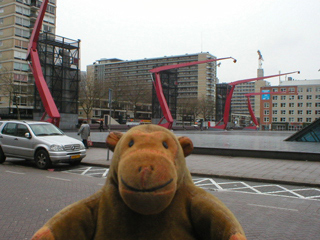 Mr Monkey looking at light gantries on Schouwburgplein