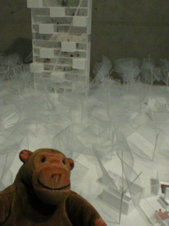 Mr Monkey looking at a model in the Europan 9 exhibition