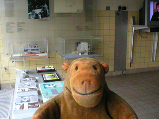 Mr Monkey looking at at an exhibition in the garage