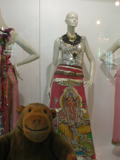 Mr Monkey looking at a metal vest and full length Ganesha coin skirt