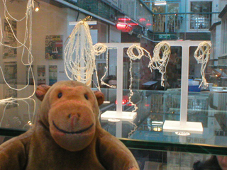 Mr Monkey looking at porcelain earrings and necklaces