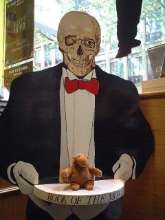Mr Monkey on a tray held by skull headed butler