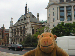 Mr Monkey  looking at the old City of London School for Boys from Blackfriars bridge