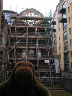 Mr Monkey looking at Winchester Palace shrouded in scaffolding
