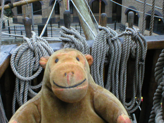 Mr Monkey examining belaying pins holding the ship's rigging in place