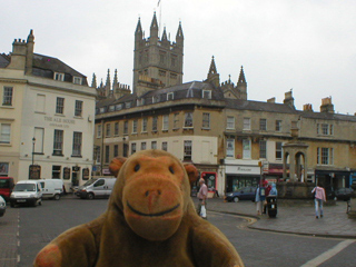 Mr Monkey looking at the Abbey Church towering over the houses