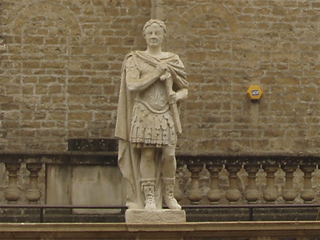 A statue standing on the terrace above the Great Bath