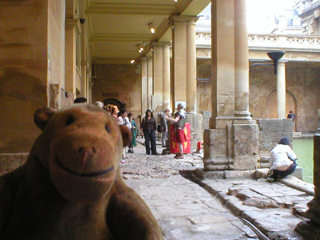 Mr Monkey watching a legionary explain the baths