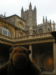 Mr Monkey looking up at the tower of Bath Abbey