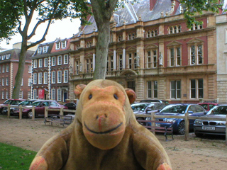 Mr Monkey looking at buildings around Queen Square