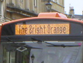 An LED display on a bus reading The Bright Orange