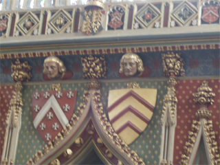Brightly painted shields and heads on the Eastern Lady chapel reredos