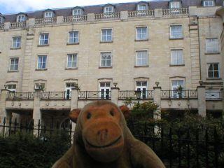 Mr Monkey looking at the Marriot hotel from the cathedral grounds