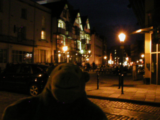 Mr Monkey looking down King Street at night