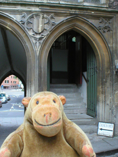 Mr Monkey outside the door of St John the Baptist's