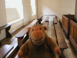 Mr Monkey inspecting benches on the upper floor of the Chapel