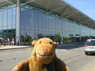 Mr Monkey looking at the Bristol airport terminal building