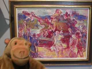 Mr Monkey looking at a garish picture of a Communist tank 