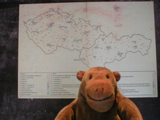 Mr Monkey looking at a map showing police sites across Czechoslovakia