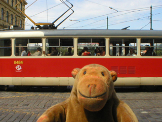 Mr Monkey looking at a Prague tram