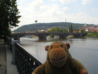 Mr Monkey looking towards the Mánesův Bridge