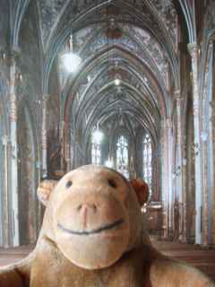 Mr Monkey in front of a picture of the nave of the church of SS Peter and Paul