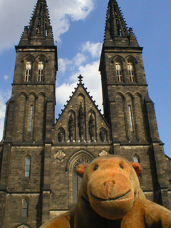 Mr Monkey looking up at the towers of the church