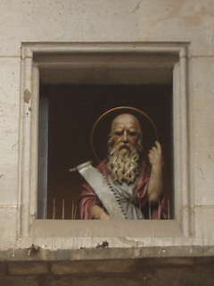 A saint with a large double handed saw