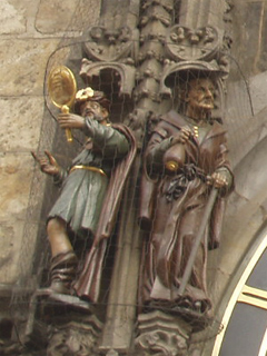 Vanity and Greed to the left of the clock face
